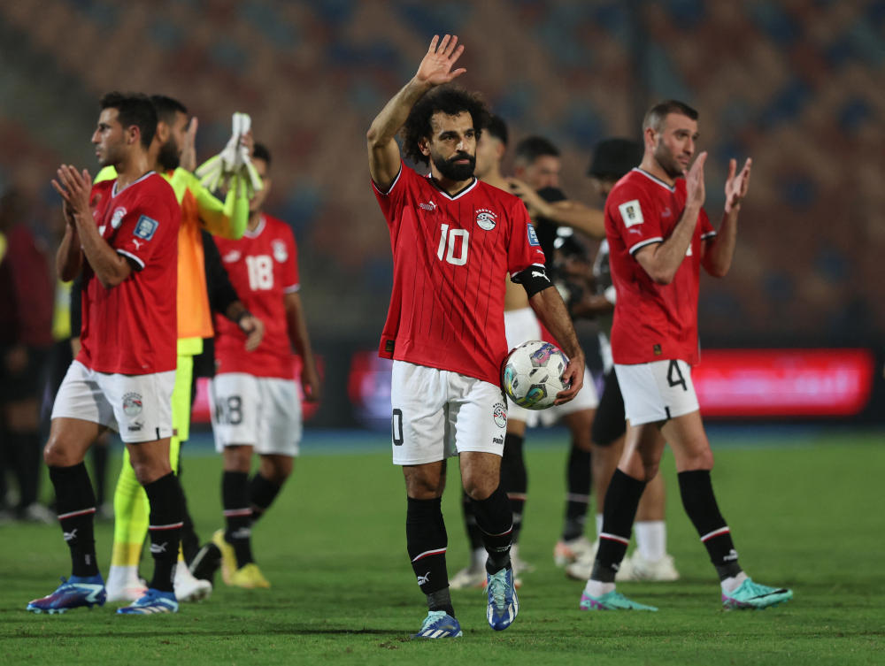 Egypt’s Mohamed Salah celebrates with a match ball after scoring four goals during their World Cup — CAF Qualifiers — Group A — against Djibouti at Cairo International Stadium, on Nov. 16, 2023 (Reuters)
