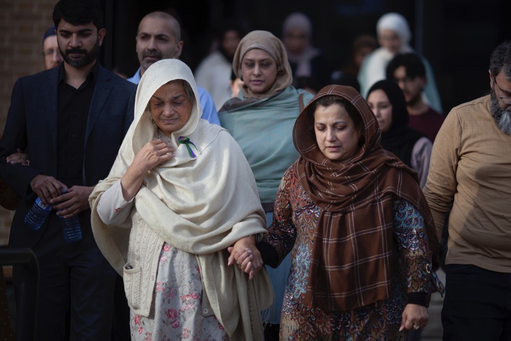 Family and friends of the Afzaal family, including Tabinda Bukhari, front-left, the mother of Madiha Salman, exit the Superior Court of Justice after a verdict in the Nathaniel Veltman murder trial was reached, on Thursday, Nov. 16, 2023, in Windsor, Canada. (The Canadian Press via AP)