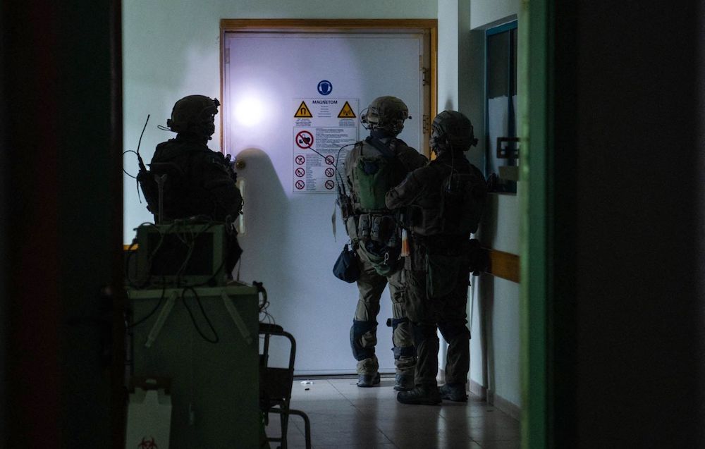 Above, Israeli soldiers inside Al-Shifa hospital in Gaza City in this picture released on Nov. 15, 2023. (Israeli army via AFP)