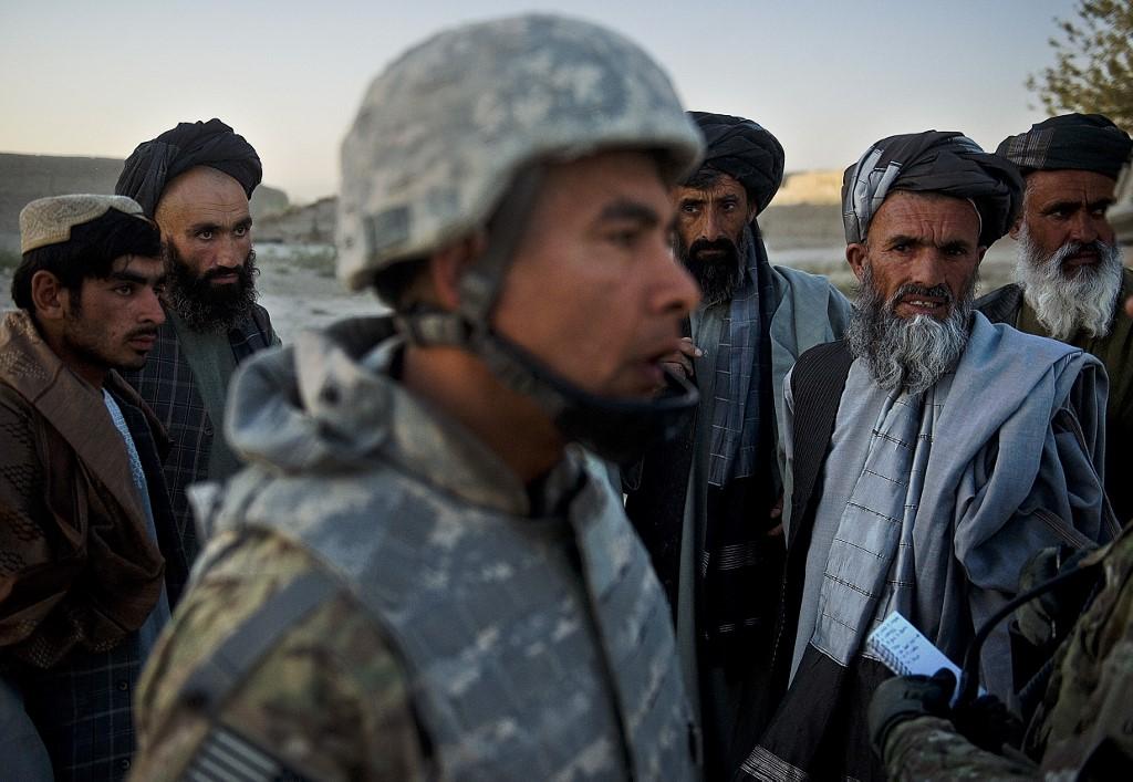 Afghan villagers look at a translator embedded with NATO troops in this September 24, 2012 photo. (AFP/File)