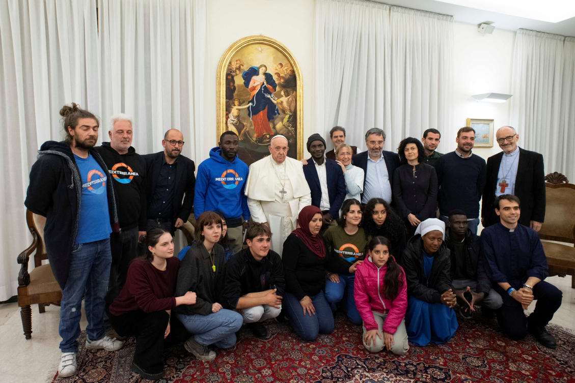 Pope Francis poses for a group photo as he meets with Mbengue Nyimbilo Crepin, nicknamed Pato, and the delegation from the Mediterranean Saving Humans, at the Vatican, on Nov. 17, 2023. (Reuters)