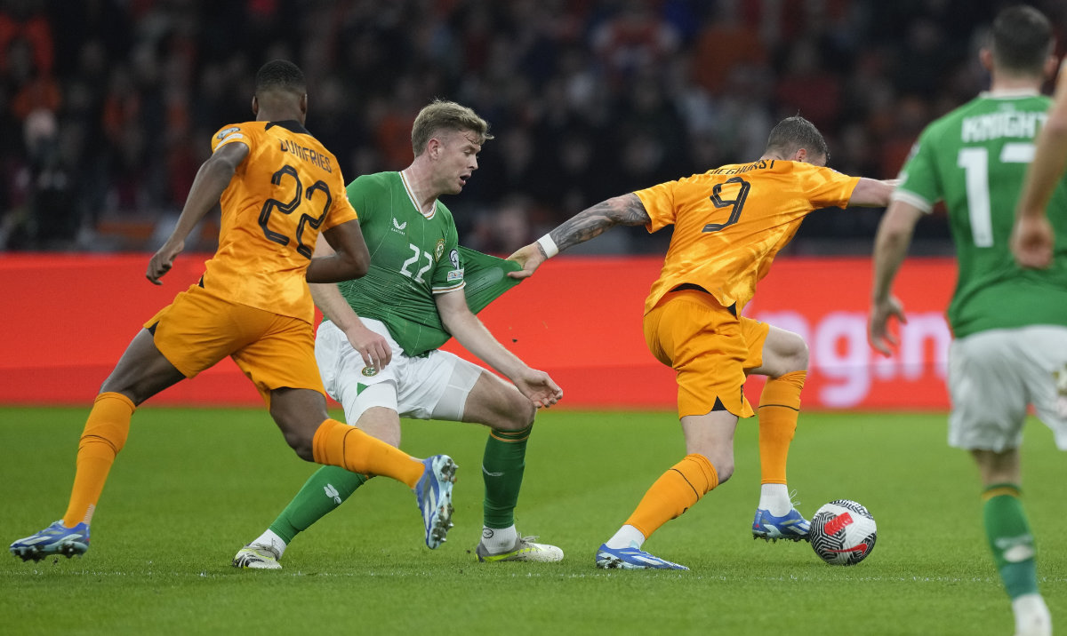 Netherlands' Wout Weghorst, second right, breaks away from Ireland's Matt Doherty, second left, to score his side's first goal during the Euro 2024 group B qualifying soccer match between the Netherlands and Ireland on Nov. 18, 2023. (AP)