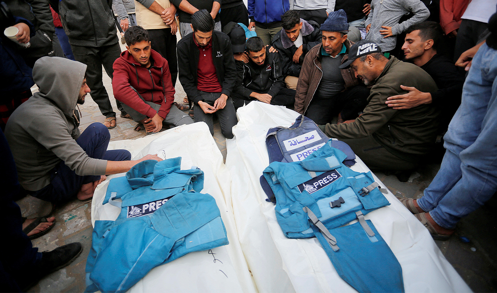 Palestinians mourn local journalists Hassouna Sleem and Sary Mansour, who were killed in an Israeli strike on a house, at a hospital in the central Gaza Strip November 19, 2023. (REUTERS)