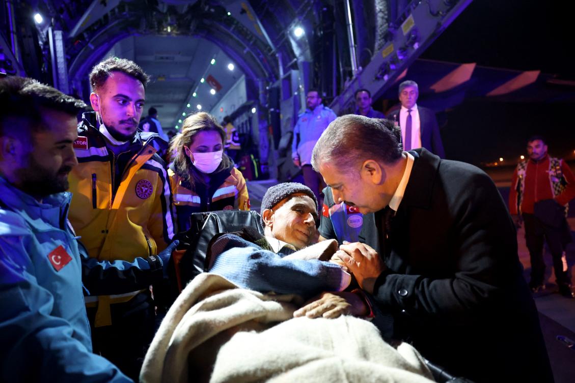 Turkish Health Minister Fahrettin Koca speaks with a Palestinian cancer patient who had arrived at the Esenboga Airport in Ankara last week. (File/AFP)