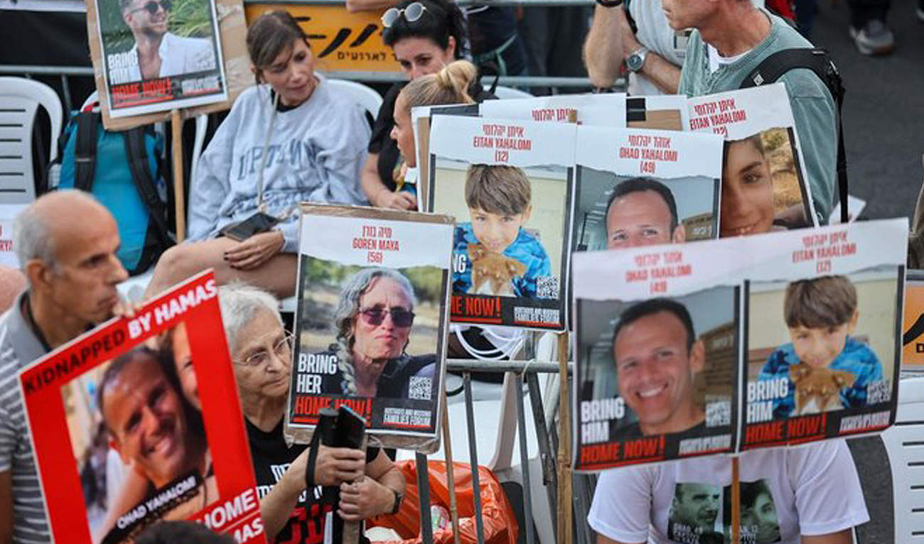 Family members, friends and supporters of hostages held in the Gaza Strip since the October 7 attack by Hamas militants in southern Israel, hold images of those taken during a protest calling for their release outside the Prime Minister's office in Jerusalem (AFP)
