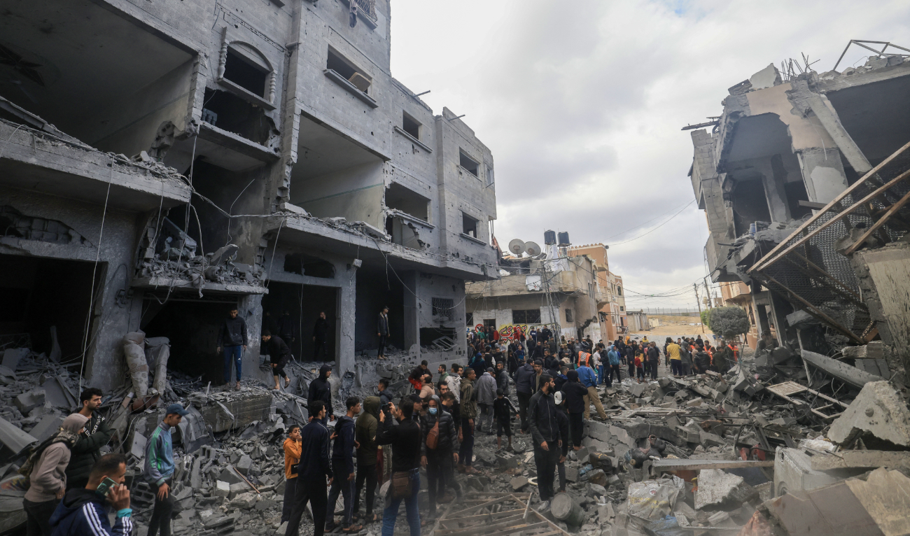 Palestinians walk amid the rubble of buildings damaged during an Israeli strike on Rafah in the southern Gaza Strip on November 20, 2023. (AFP)