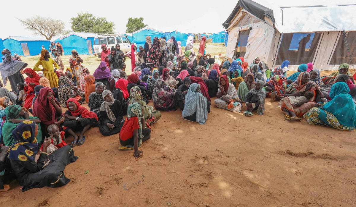 Women who fled the war in Sudan await the distribution of international aid rations at the Ourang refugee camp, near Adre town in eastern Chad on August 15, 2023. (AFP)