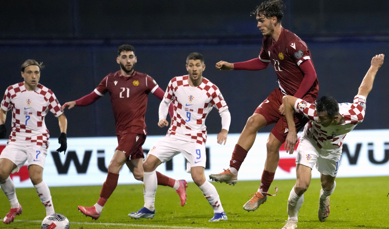 Croatia's Ante Budimir, right, scores against Armenia with a header during the Euro 2024 group D qualifying soccer match between Croatia and Armenia at the Maksimir Stadium in Zagreb Tuesday. (AP)