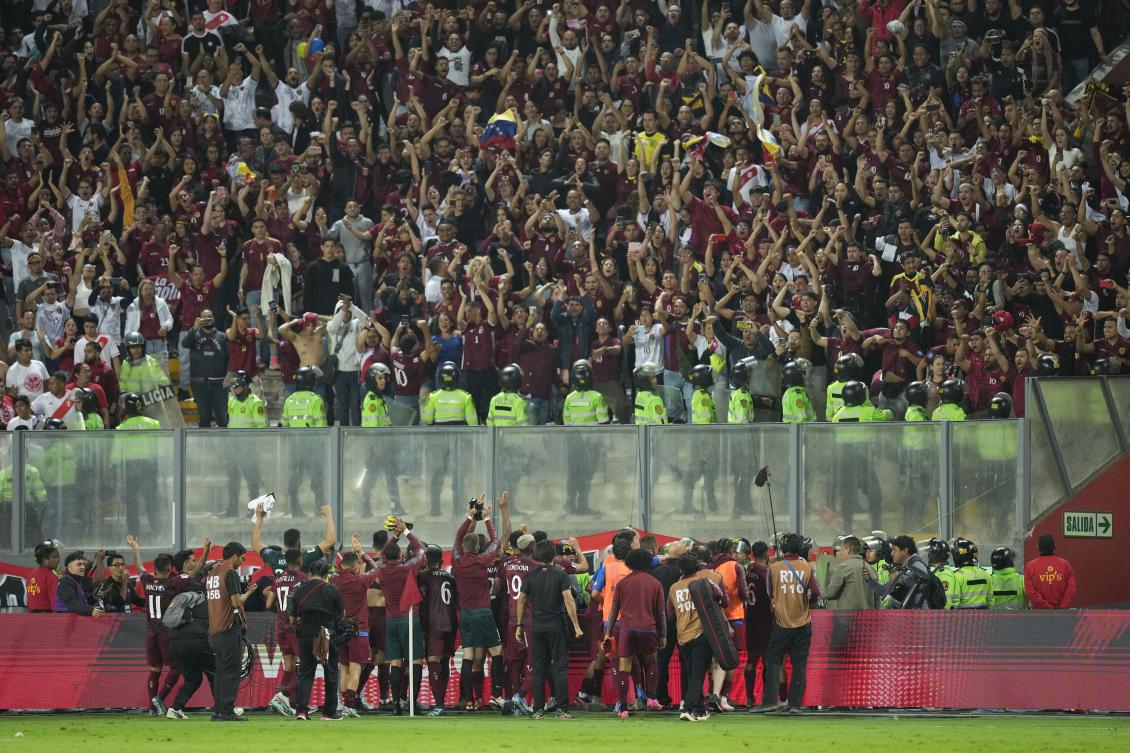 Venezuela players celebrate after draw with Peru 1-1 during a qualifying soccer match for the FIFA World Cup 2026 at the National stadium in Lima, Peru, on Nov. 21, 2023. (AP)