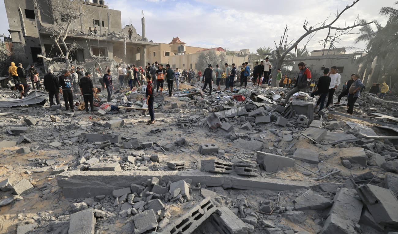 Palestinians inspect the damage after an Israeli strike on a house in Khan Yunis, in the southern Gaza Strip on November 22, 2023. (AFP)