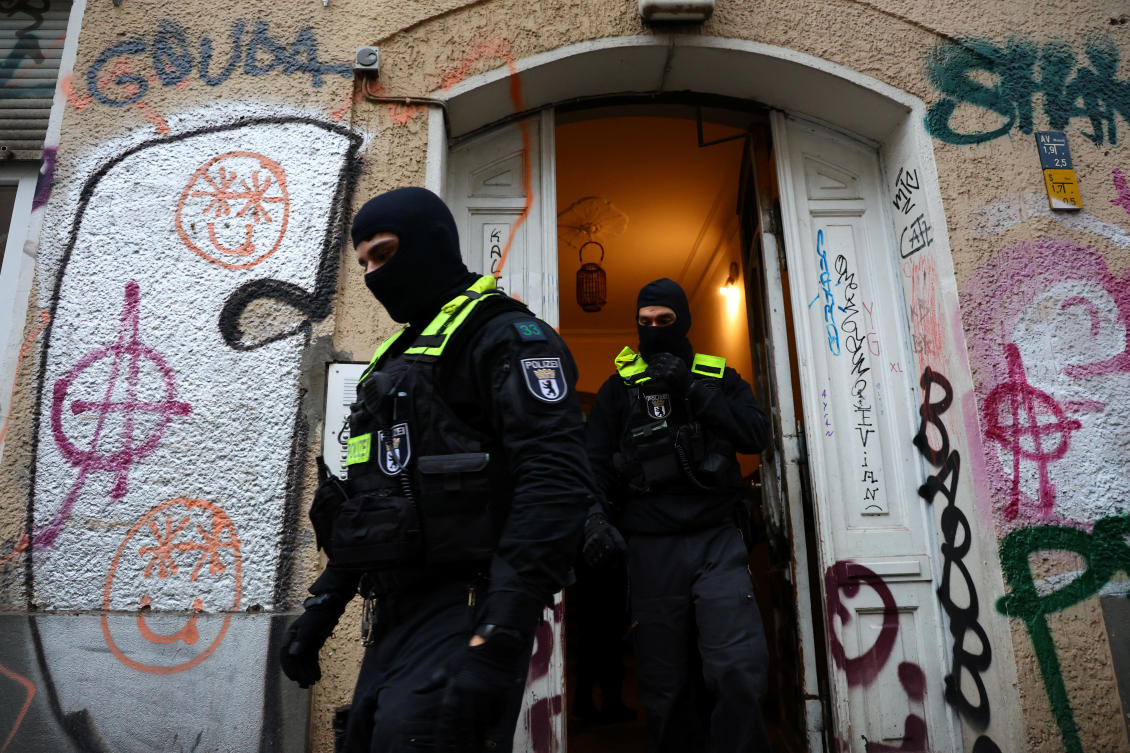 German police officers leave a house during a raid against people supporting the Palestinian Islamist group Hamas (REUTERS)