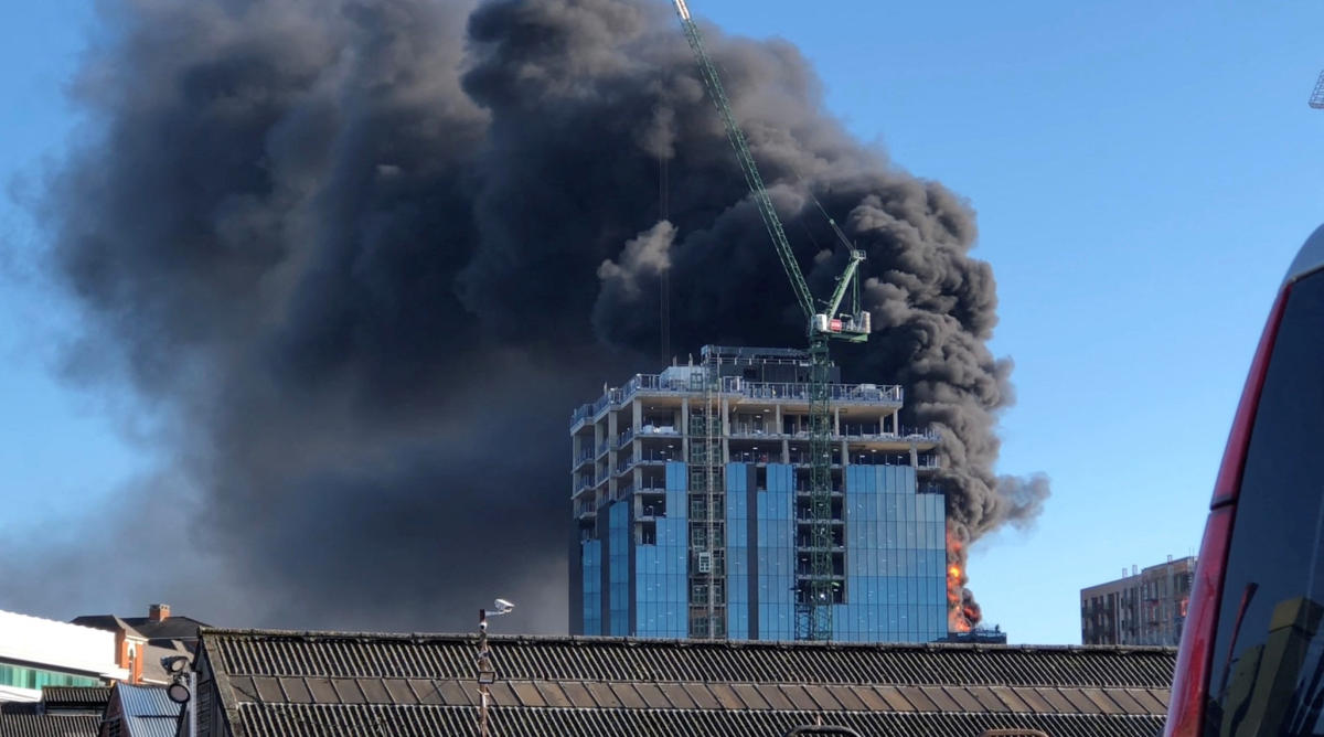 A crane operator has rescued a man from a burning high-rise in England