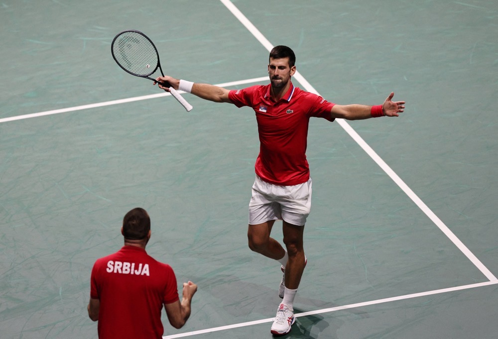 Serbia’s Novak Djokovic celebrates with captain Viktor Troicki after winning his Davis Cup quarterfinal match against Britain’s Cameron Norrie on Thursday. (Reuters)
