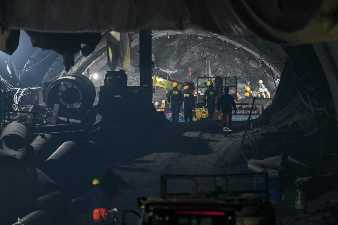 Just a few meters of rock and earth separate Indian rescue teams from 41 workers who have been trapped inside a collapsed road tunnel for nearly two weeks. (AFP)
