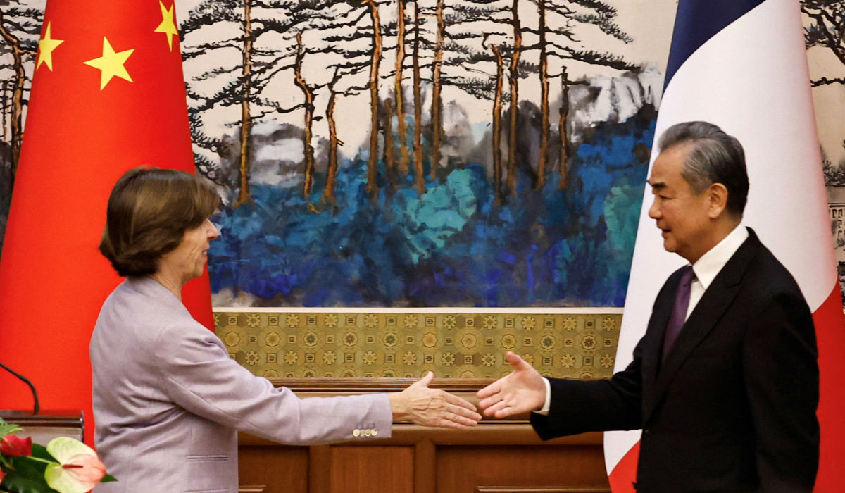 French Foreign Minister Catherine Colonna greets Chinese Foreign Minister Wang Yi following Friday’s press conference at the Diaoyutai State Guesthouse in Beijing. (Reuters)