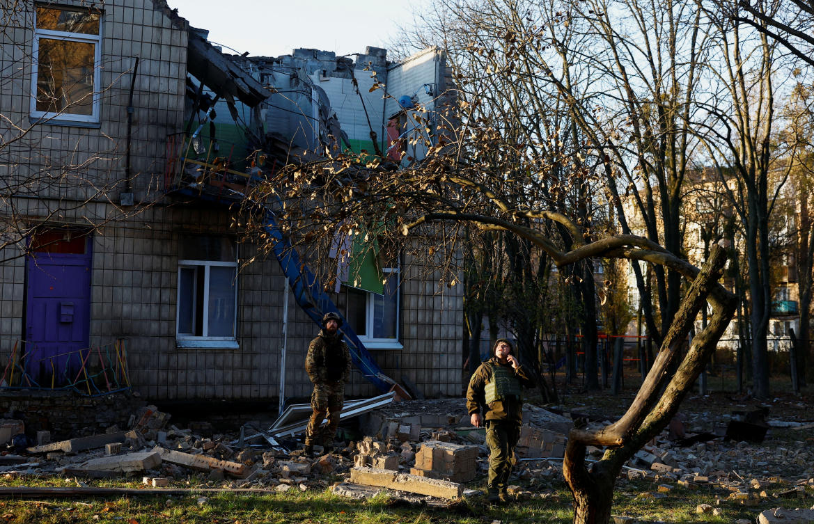 Police officers inspect the compound of a kindergarten damaged during Russian drone strikes, amid Moscow's attack on Ukraine, in Kyiv. (Reuters)
