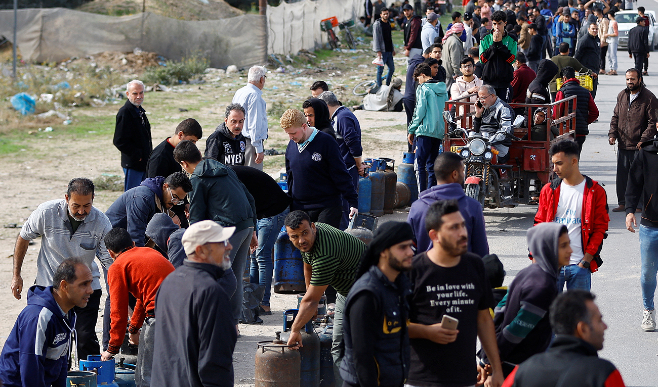 Palestinians gather to buy fuel, amid fuel shortages, during a temporary truce between Hamas and Israel, in Rafah in the southern Gaza Strip on November 25, 2023. (REUTERS)