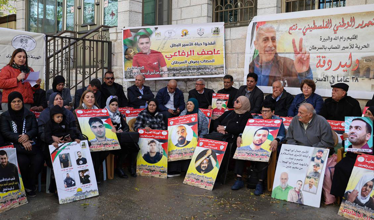 Relatives and supporters of Palestinians held in Israeli prisons stage sit-in in front of the Red Cross in the West Bank city of Ramallah, calling for their release. (AFP/File)