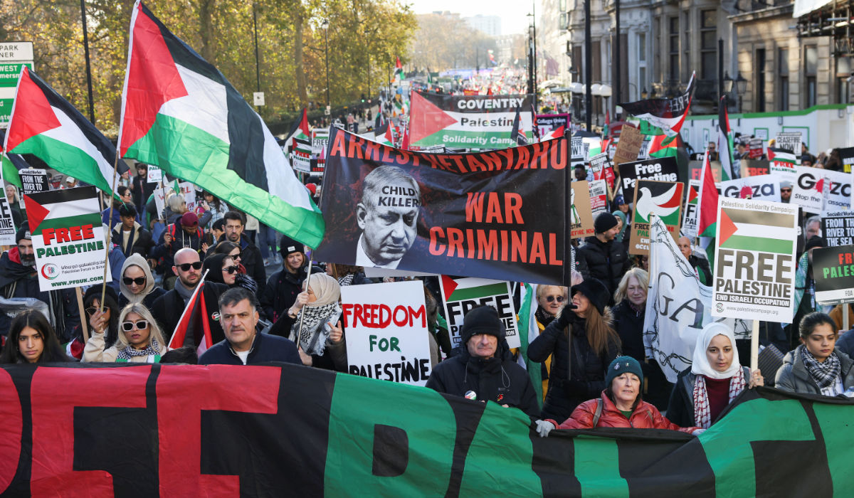 Demonstrators hold a banner featuring an image of Israeli Prime Minister Benjamin Netanyahu, during a protest in solidarity with Palestinians in Gaza, during a temporary truce between Palestinian Islamist group Hamas and Israel, in London, Britain, November 25, 2023. (REUTERS)