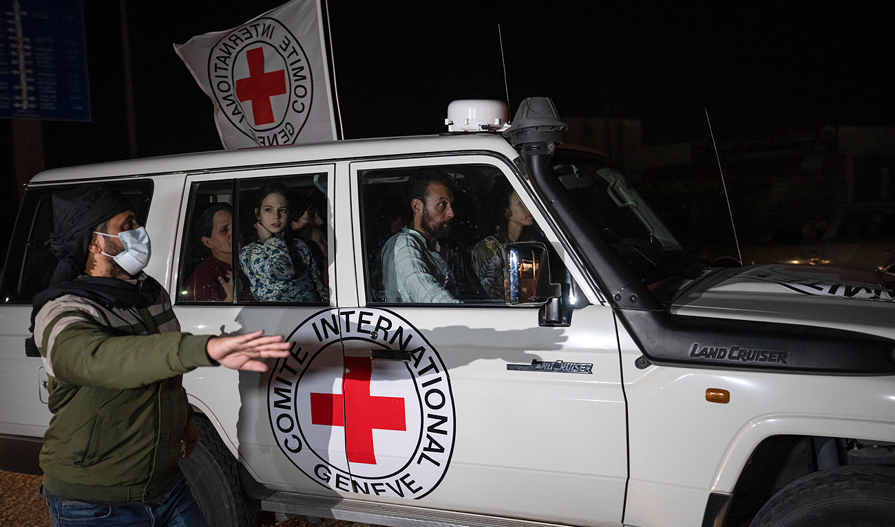 A Red Cross vehicle carrying Israeli hostages drives by at the Gaza Strip crossing into Egypt in Rafah on Saturday, Nov. 25, 2023. (AP)