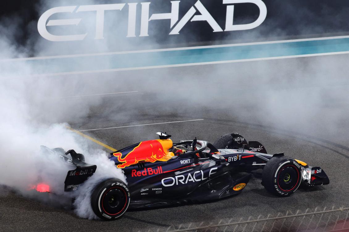 Red Bull Racing’s Dutch driver Max Verstappen performs a burnout after winning the Abu Dhabi Formula One Grand Prix at the Yas Marina Circuit. (AFP)