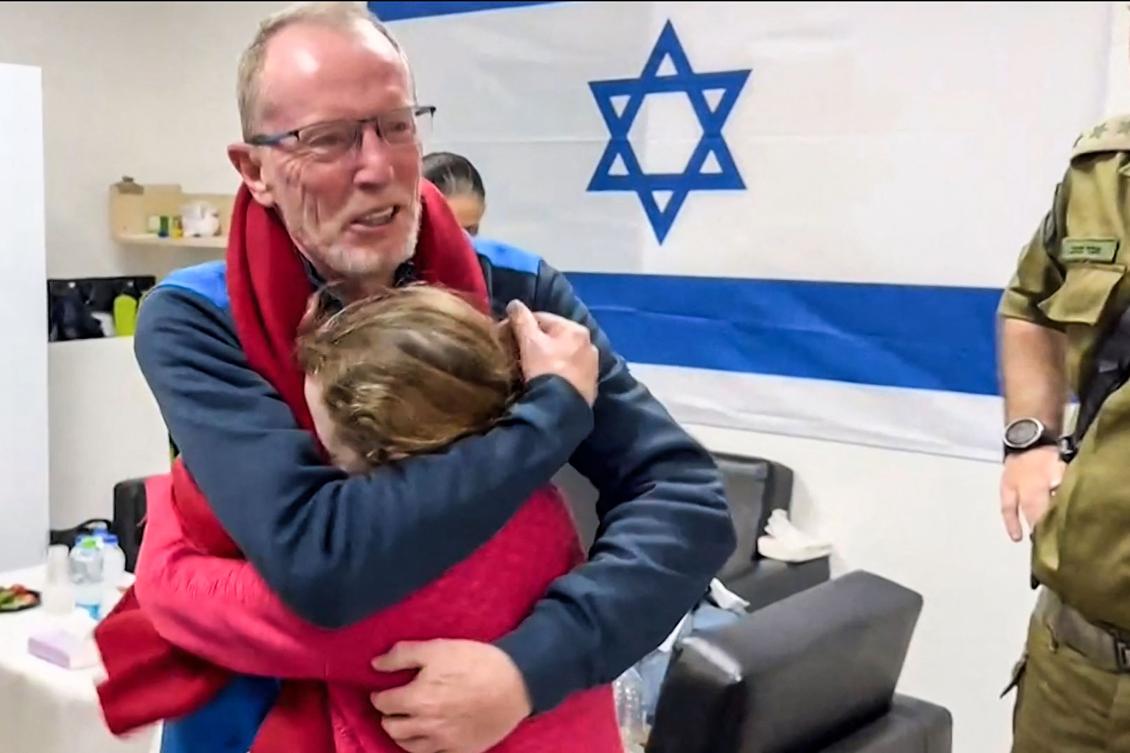 A handout video released by the Israeli army, shows 9-year-old Irish Israeli former hostage Emily Hand embracing her father at a hospital in Israel after being released by Hamas. (AFP)