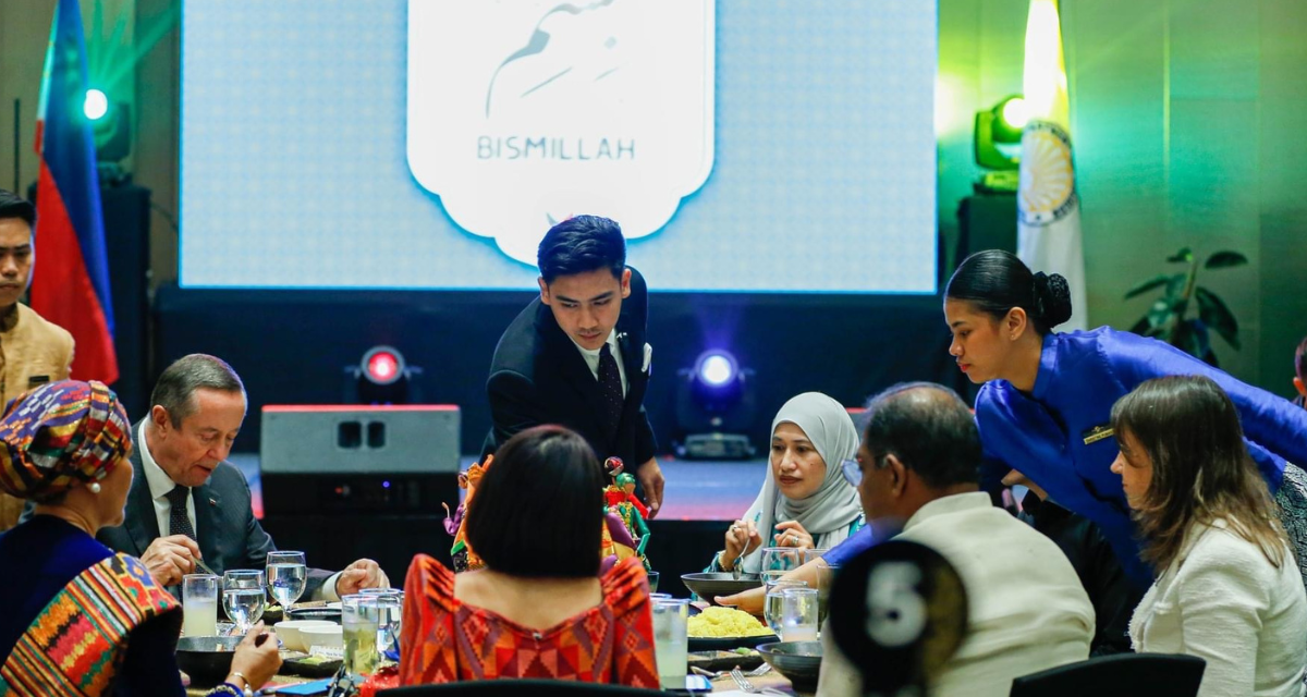 Servers place Mindanao dishes on the table for guests at an event hosted by the Philippine Department of Tourism to promote halal food from the region in Makati City. (Supplied)