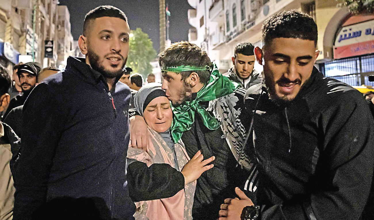 A Palestinian prisoner hugs his mother after being released from an Israeli jail. (AFP)