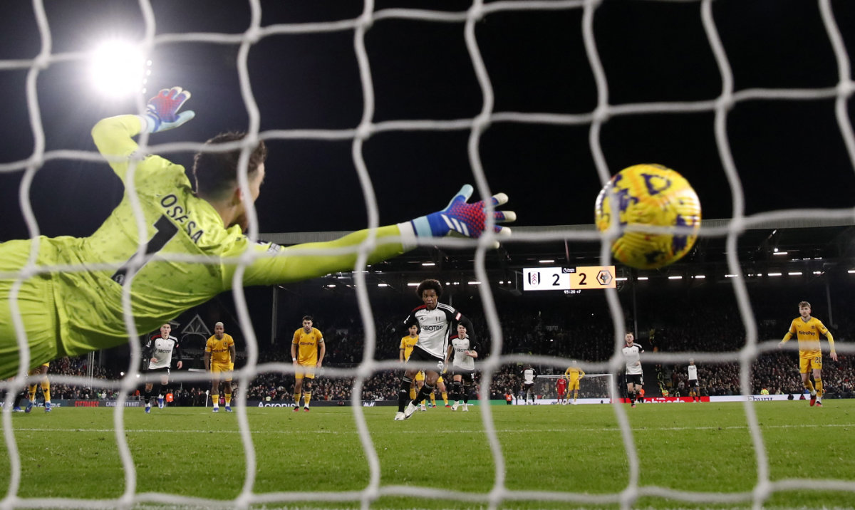 Fulham's Willian scores their third goal from the penalty spot during the Premier League match between Fulham and Wolverhampton Wanderers at Craven Cottage, London, on Monday. (Reuters)