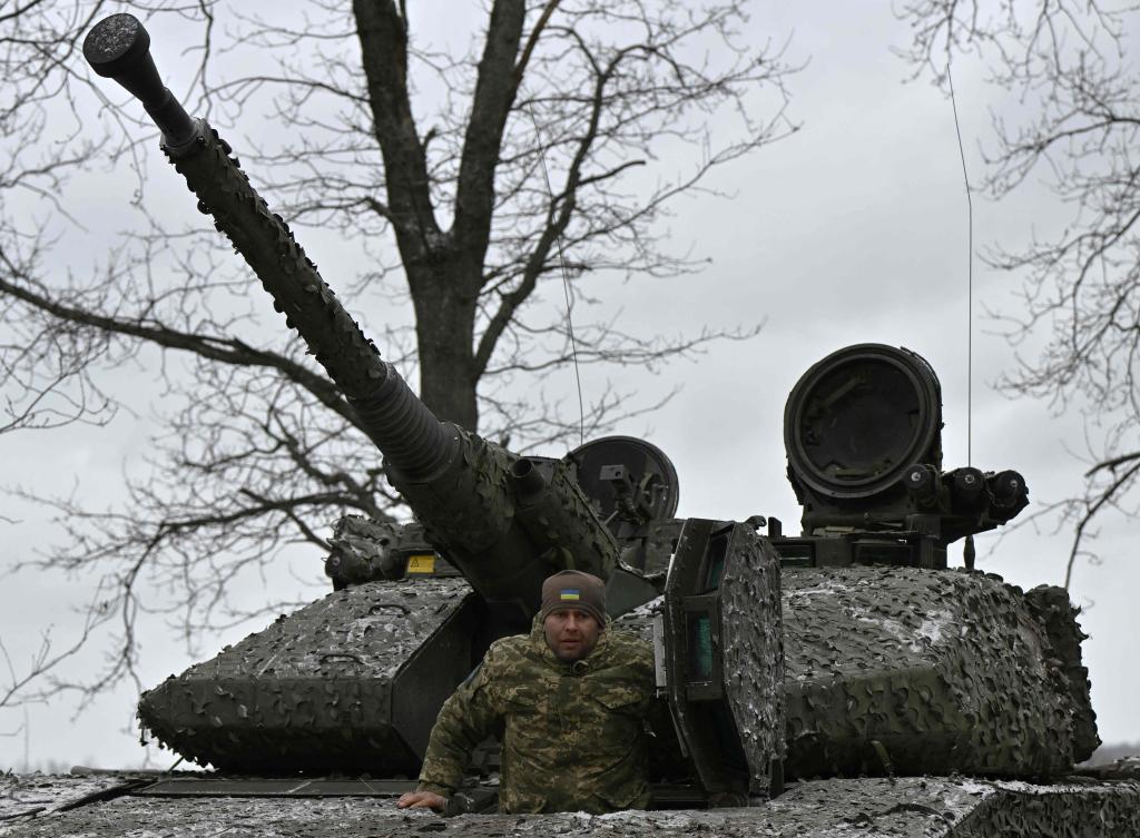 A Ukrainian serviceman stands in a Sweden made CV90 armored infantry combat vehicle on a position pointing in the direction of Bakhmut in the Donetsk region on Nov. 27, 2023. (AFP)