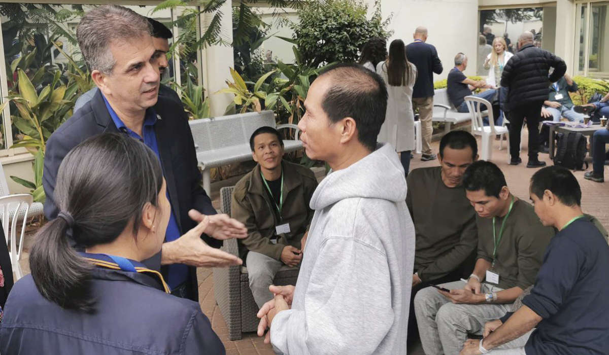 In this photo provided by Thailand's Foreign Ministry, Israel's Foreign Minister Eli Cohen, left, talks to one of the freed Thai hostages at the Shamir Medical Center in Israel Saturday, Nov. 25, 2023. (AP)