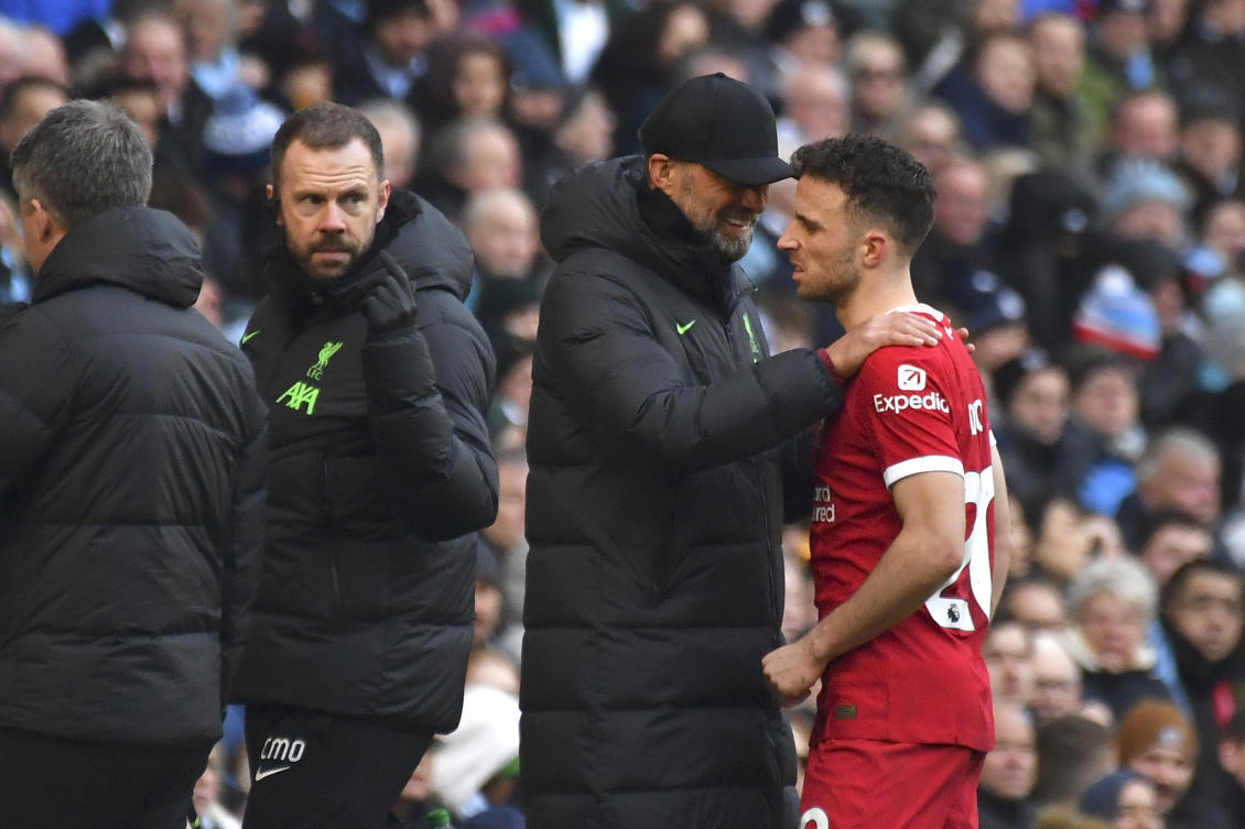 Liverpool's manager Jurgen Klopp comforts Diogo Jota as he walks off after being injured during their English Premier League match against Manchester City at Etihad stadium on Nov. 25, 2023. (AP)