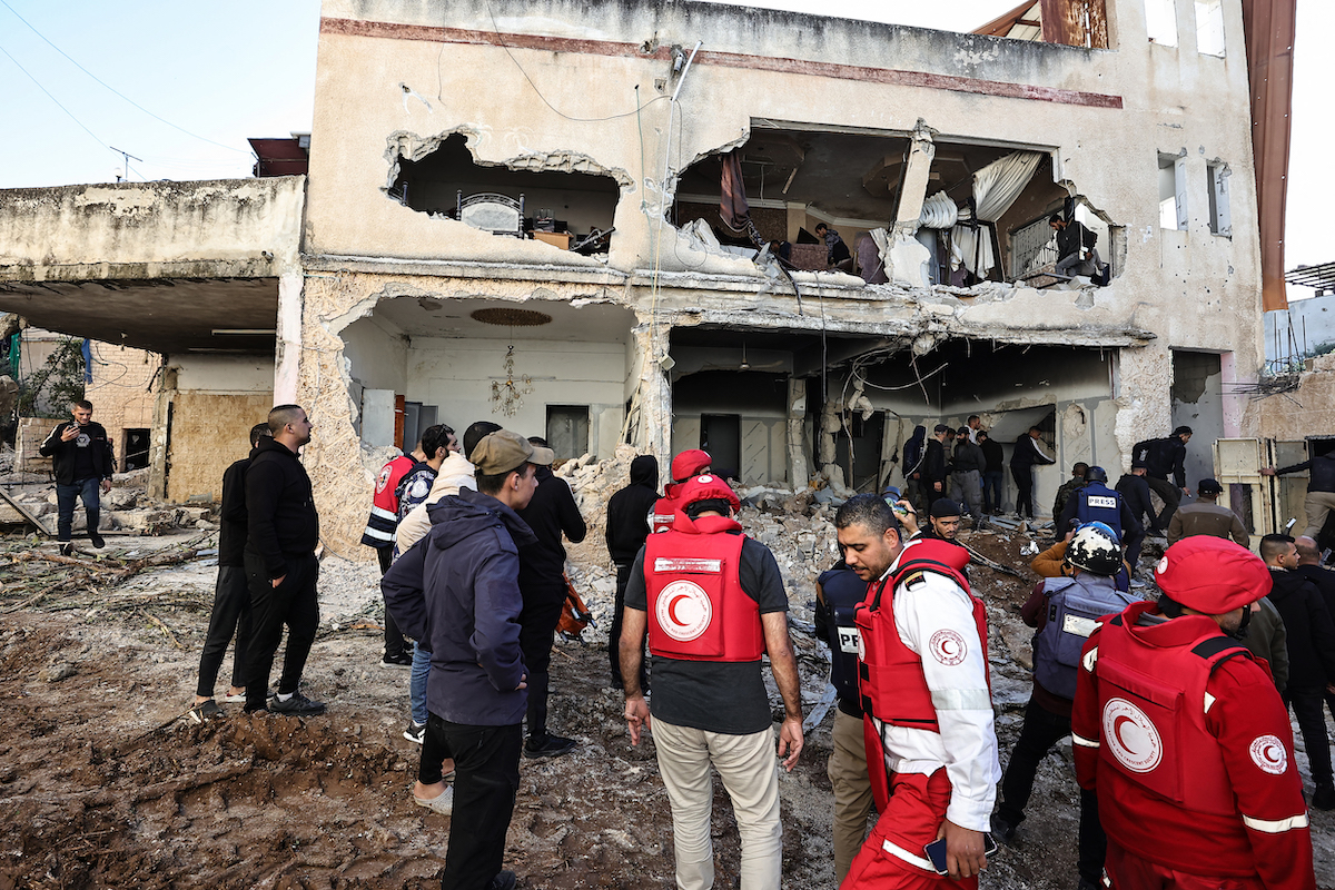 Residents and rescuers check the damage of a house following an Israeli raid in the occupied West Bank city of Jenin. (File/AFP)
