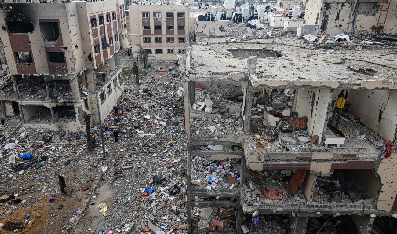 Palestinians inspect the destruction caused by Israeli strikes in Wadi Gaza, central Gaza strip. some buildings in the besieged enclave have been reduced to piles of broken concrete and metal rods. (AFP)