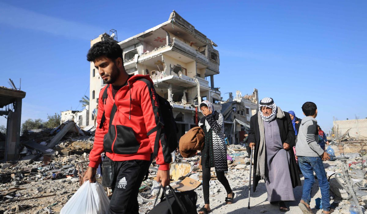 Palestinians walk through debris upon their return to Khan Yunis to inspect their homes following weeks of Israeli bombardment.