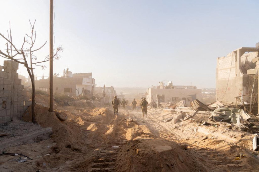 Israeli soldiers take position, amid the ongoing ground operation of the Israeli army against Hamas in the Gaza Strip. (Reuters)