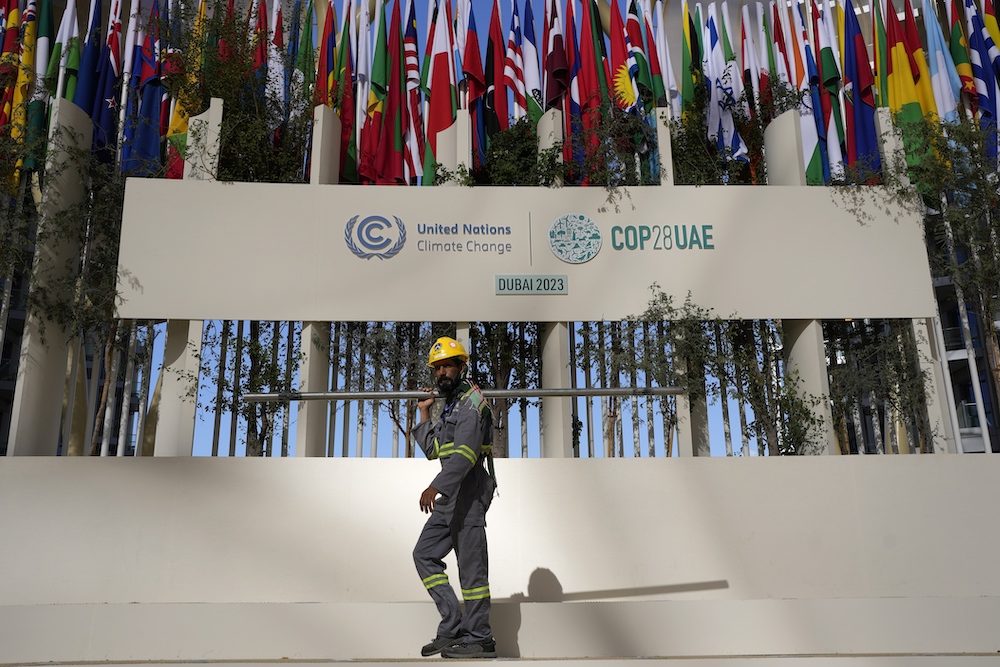 A worker sets up at the COP28 UN. Climate Summit on Nov. 30, 2023 in Dubai. (AP)