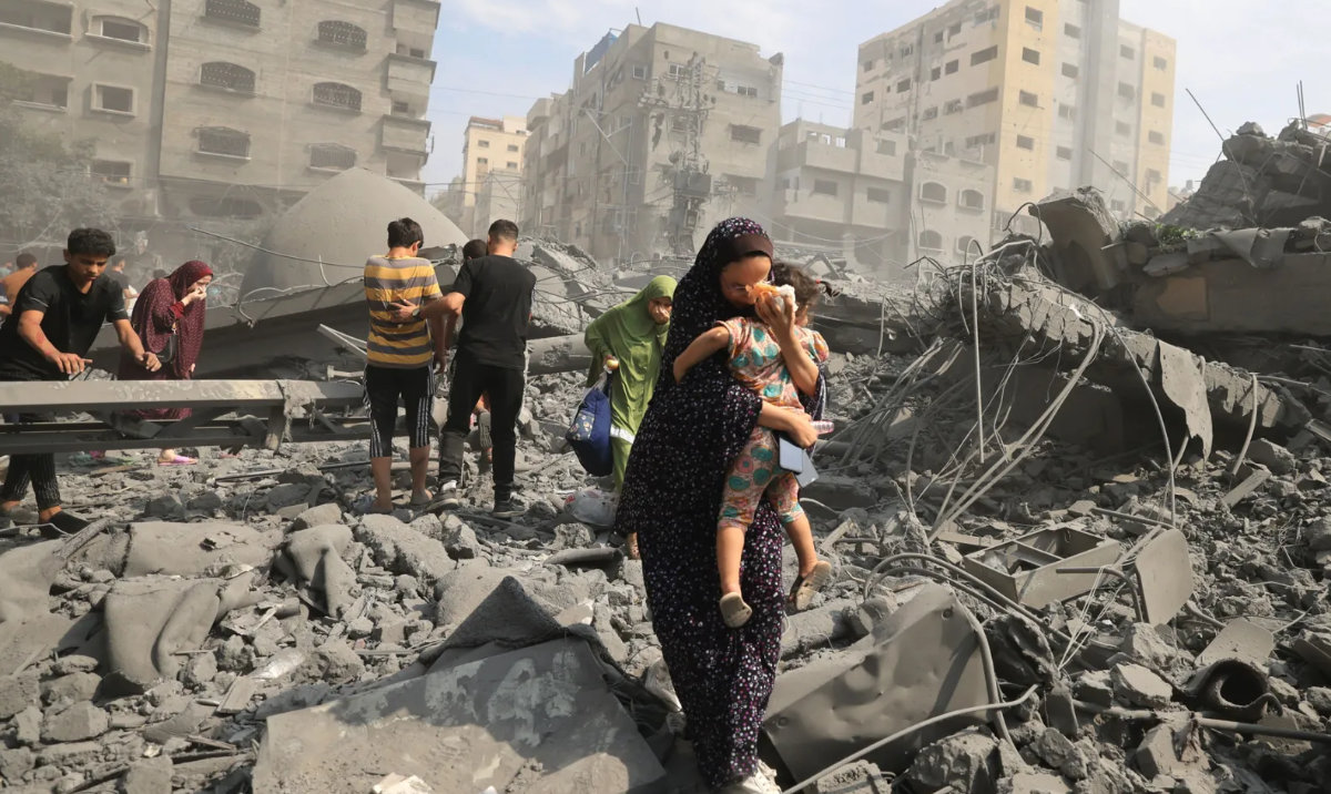 Palestinians evacuate the area following an Israeli airstrike on the Sousi mosque in Gaza City. (AFP)