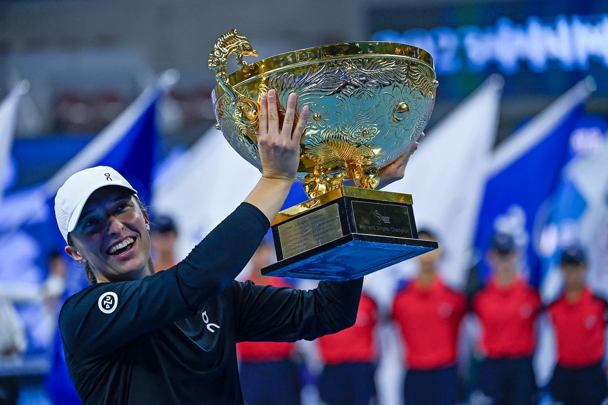 Poland's Iga Swiatek holds the winning trophy after defeating Russia's Liudmila Samsonova in the women's singles final match of the WTA China Open tennis tournament in Beijing on Oct. 8, 2023. (File/AFP)