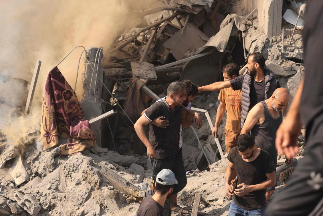 People search for victims and survivors through the rubble of a building destroyed in an Israeli strike on the Bureij refugee camp in the central Gaza Strip on Nov. 2, 2023. (AFP)