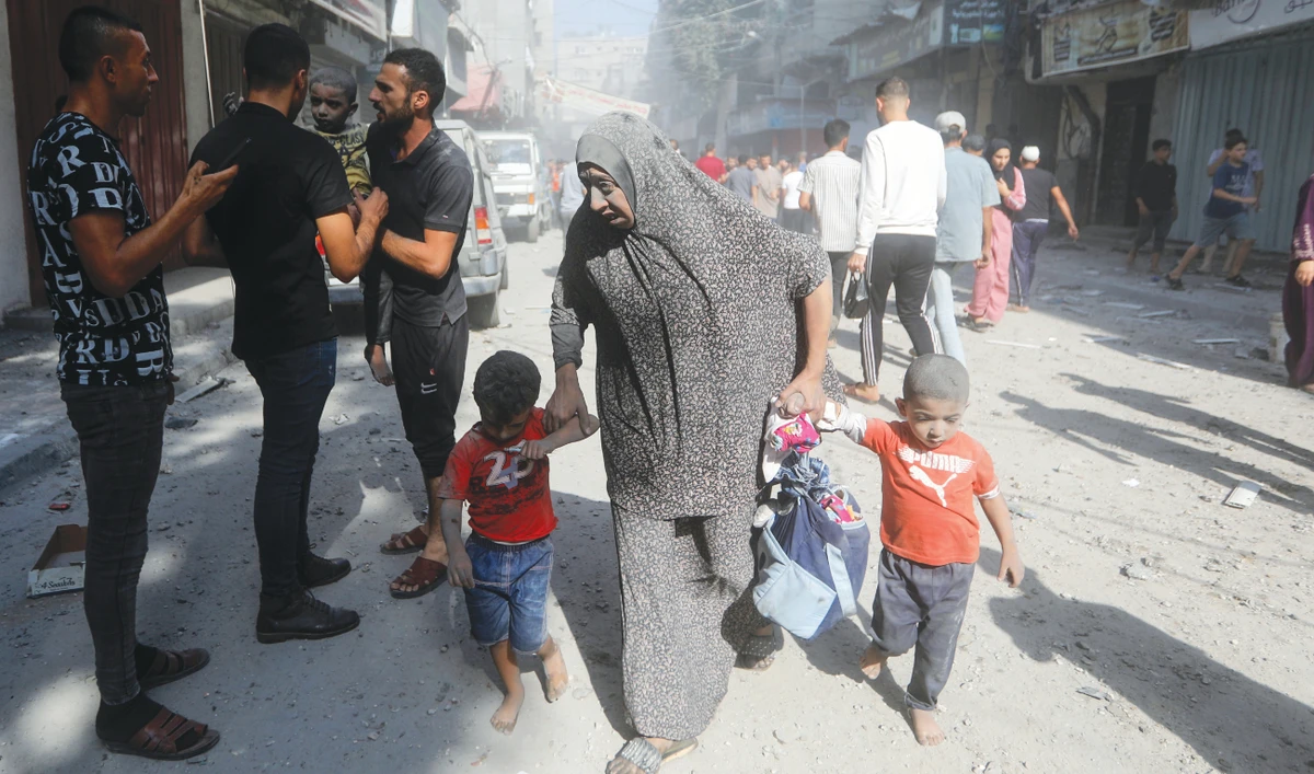 Palestinians evacuate civilians following an Israeli airstrike in the Gaza Strip. The death toll from nearly four weeks of air and artillery strikes has risen past 9,000. (AP)