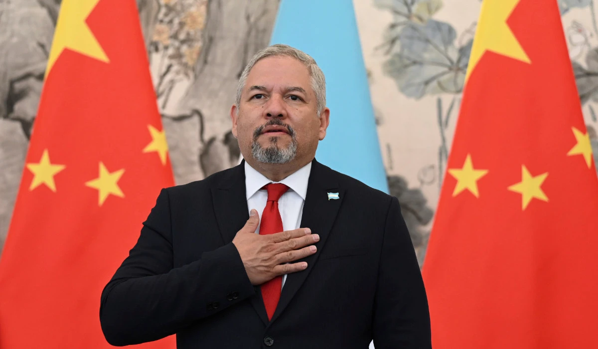 Foreign Minister Eduardo Enrique Reina of Honduras stands for the playing of national anthems during a ceremony in Beijing, March 26, 2023. (AP)