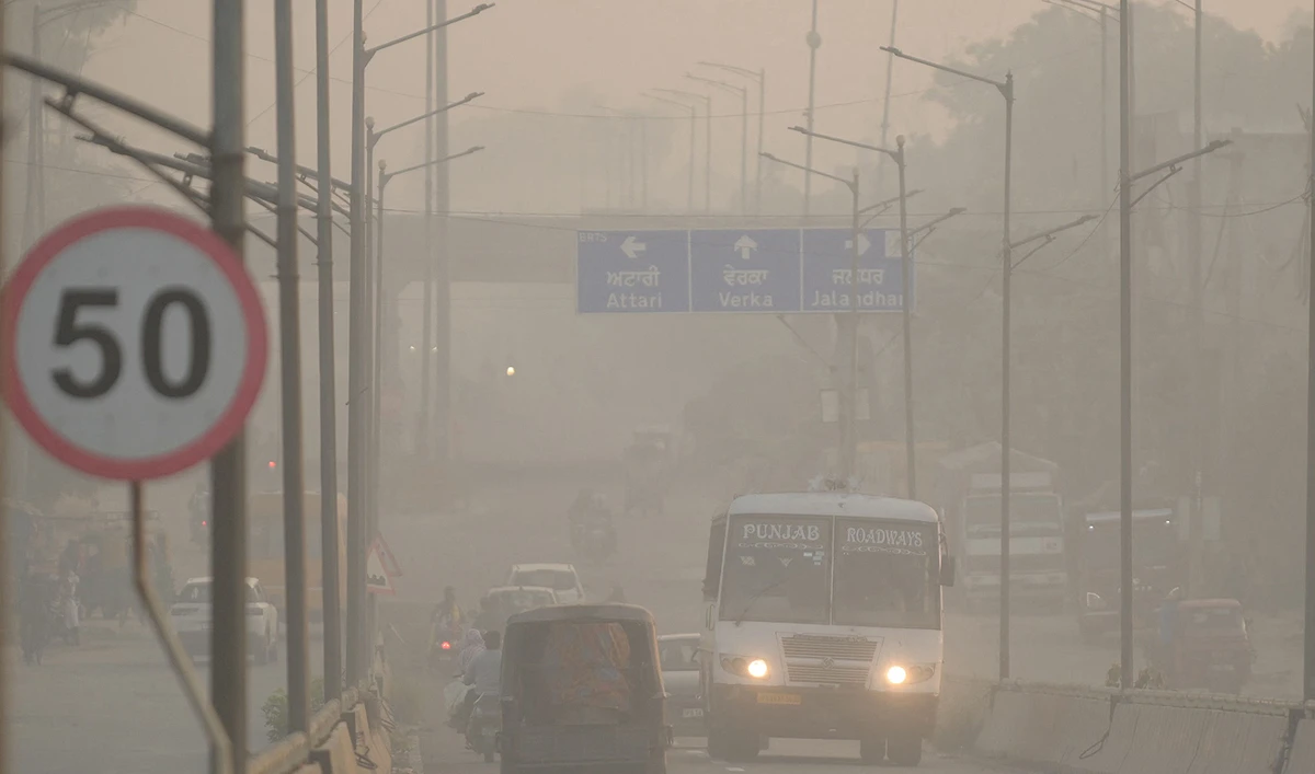 Commuters make their way along a road amid heavy smoggy conditions on the outskirts of Amritsar on November 5, 2023. (AFP)