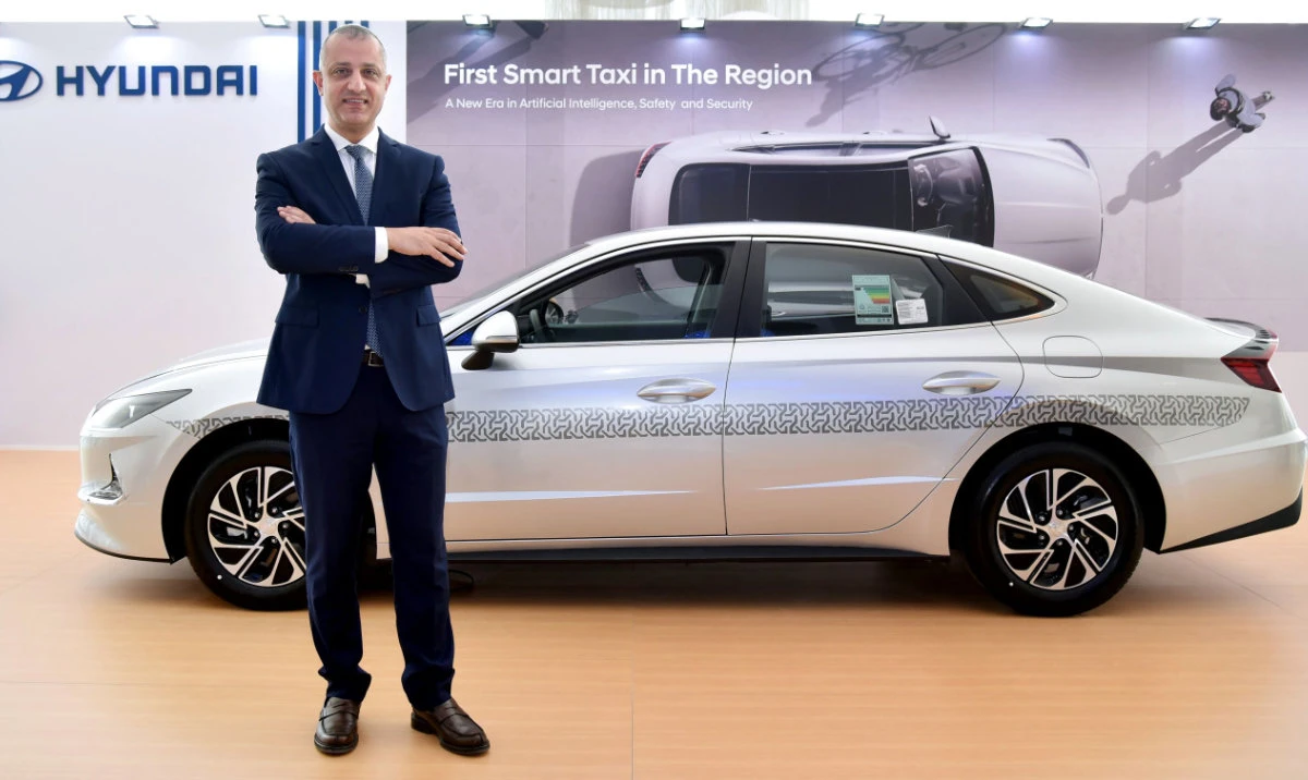 Suliman Al-Zaben, director of Hyundai, poses with the Hyundai Sonata Smart Taxi.