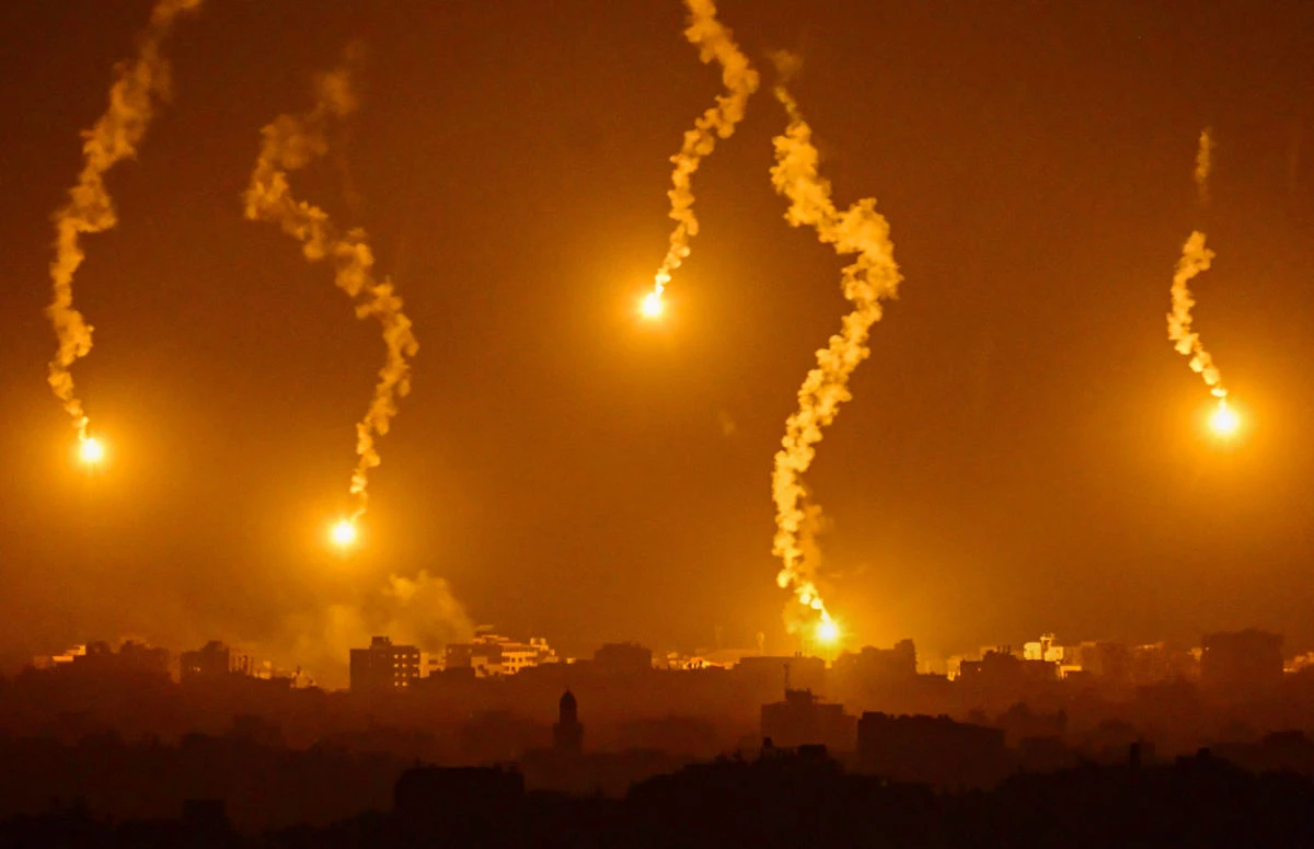 This picture taken from a position near Sderot along the Israeli border with the Gaza Strip on November 5, 2023, shows flares dropped by Israeli forces above the Palestinian enclave amid ongoing battles between Israel and the Palestinian Hamas movement. (AFP)
