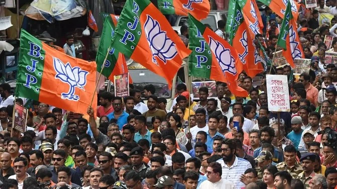 Bharatiya Janata Party (BJP) activists hold party flags during a rally in Kolkata, India, on July 19, 2023. (AFP/File)