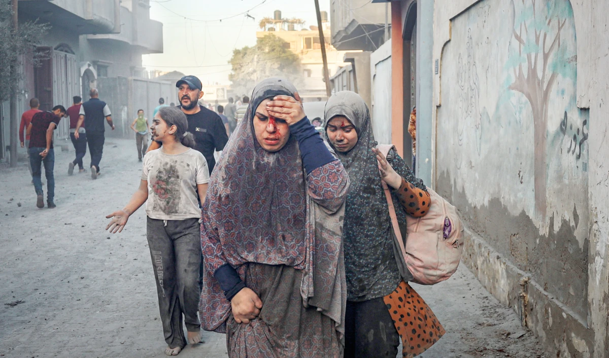 Palestinians walk away after an Israeli airstrike in Rafah, Gaza Strip, on Tuesday. (AP)
