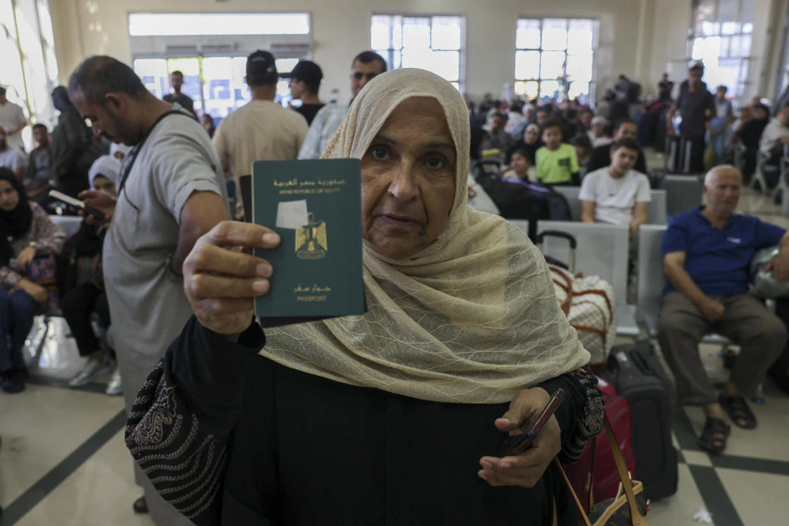 Palestinian dual nationals and foreigners have been waiting to cross the Rafah border crossing with Egypt, in the southern Gaza Strip. (AFP)