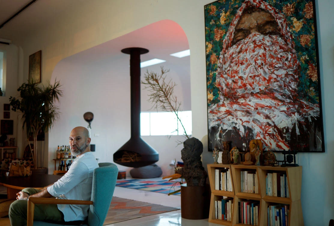 Lebanese artist Ayman Baalbaki, 48, attends an interview with Reuters inside his apartment in Beirut on Nov. 7, 2023. (Reuters)
