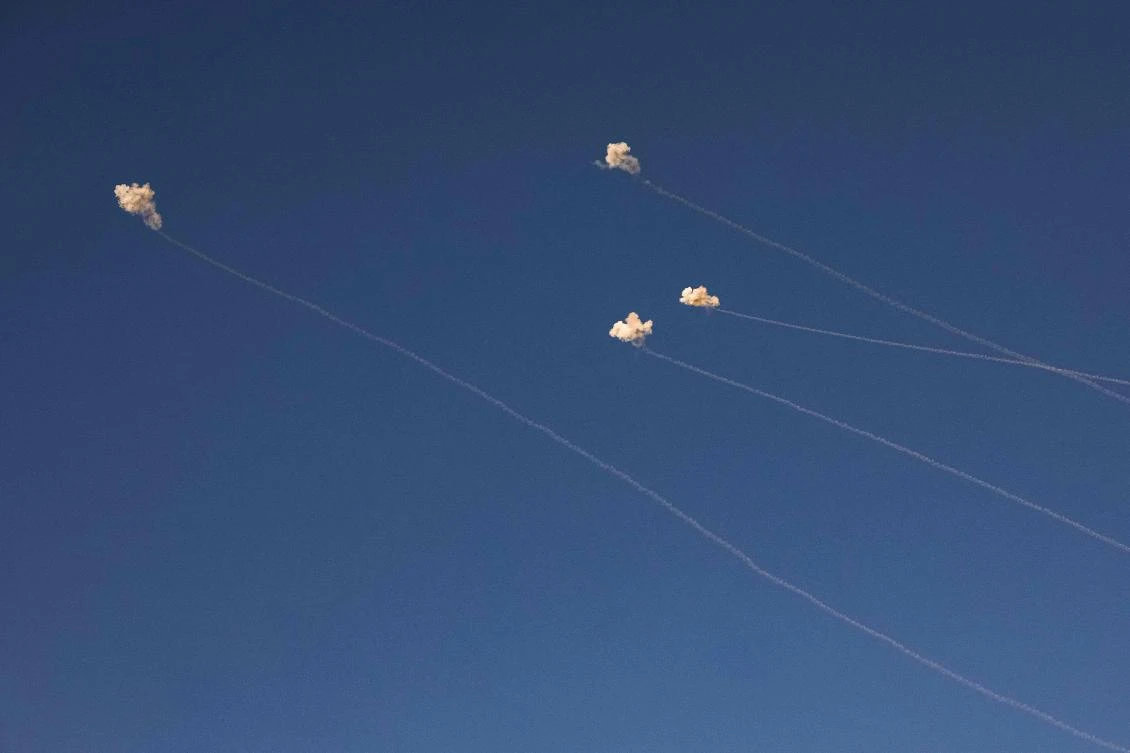 Rockets fired from southern Lebanon are intercepted above a position across the border near Kibbutz Dan in northern Israel on Nov. 7, 2023. (AFP)